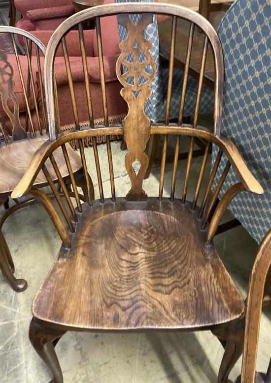 A set of eight early 20th century elm and beech Windsor wheelback dining chairs, with crinoline stretchers (two with arms)